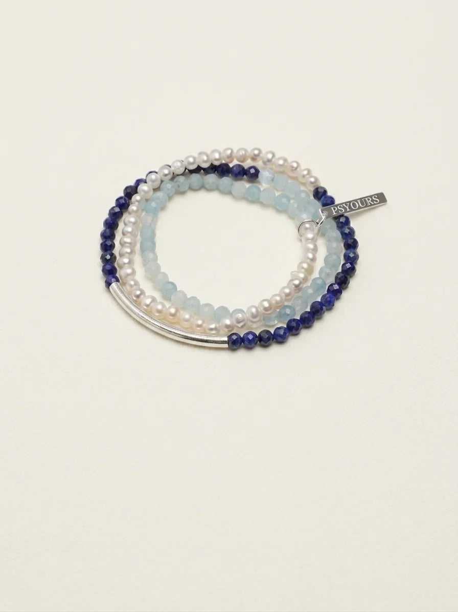 Aquamarine, lapis lazuli and pearl bracelet set on a light background