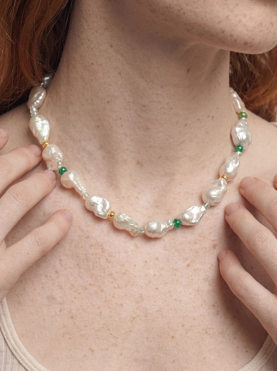 Model wearing The Story I Wear baroque pearl and gemstone necklace, close-up