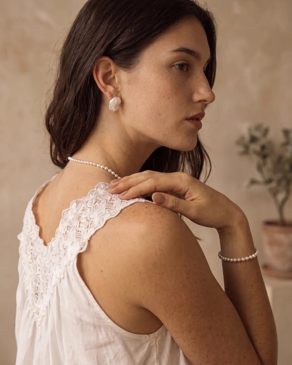 Lifestyle side view of a model wearing the freshwater pearl bracelet