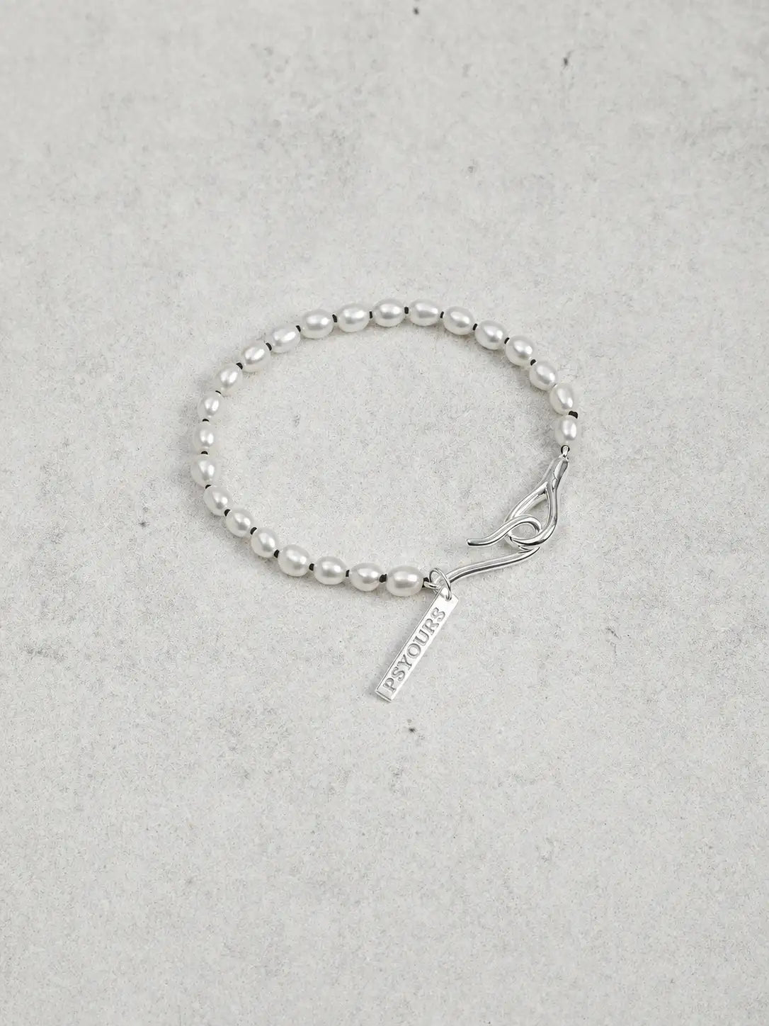 Freshwater pearl bracelet with sculptural sterling silver open clasp and name tag