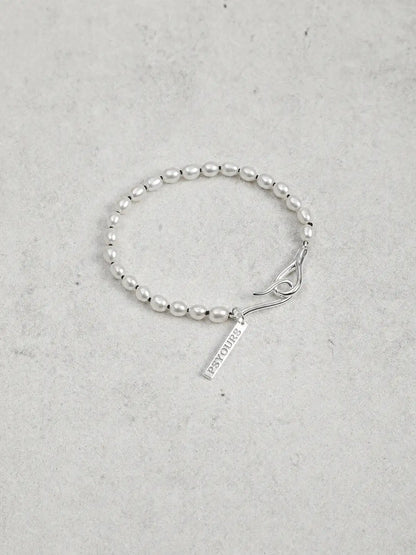 Freshwater pearl bracelet with sculptural sterling silver open clasp and name tag