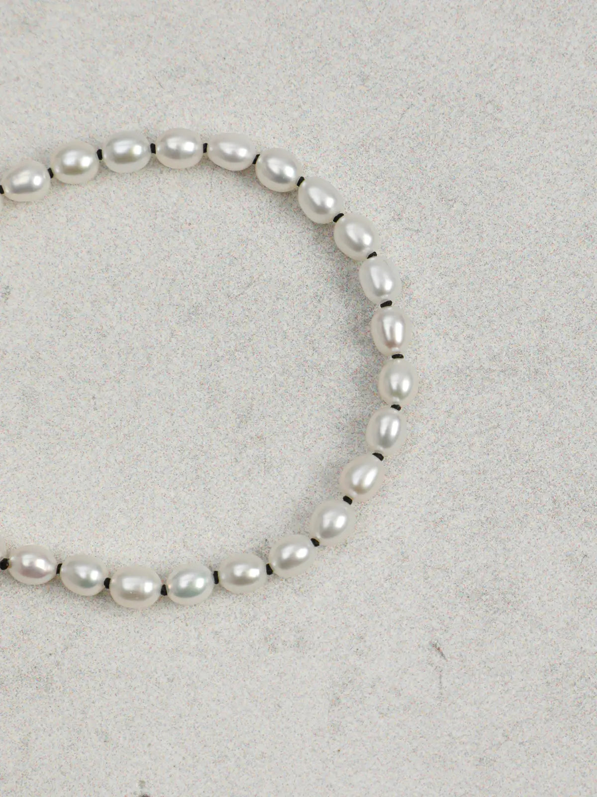 Angled view of freshwater pearl bracelet with sterling silver open clasp