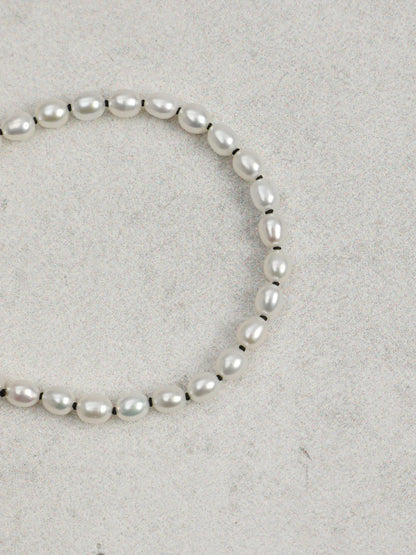 Angled view of freshwater pearl bracelet with sterling silver open clasp