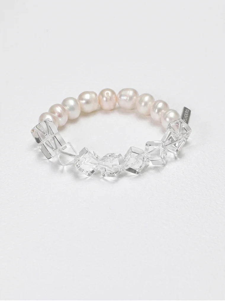 Clear quartz and freshwater pearl side of the bracelet on a white background