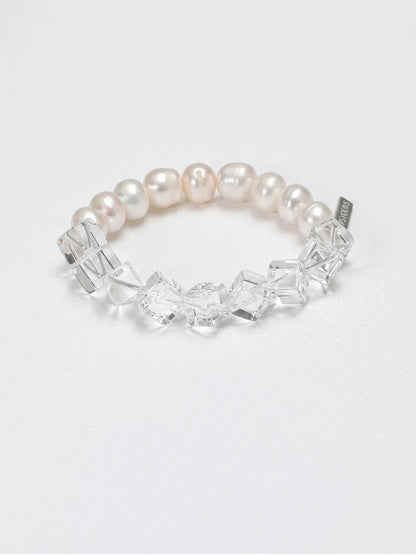 Clear quartz and freshwater pearl side of the bracelet on a white background