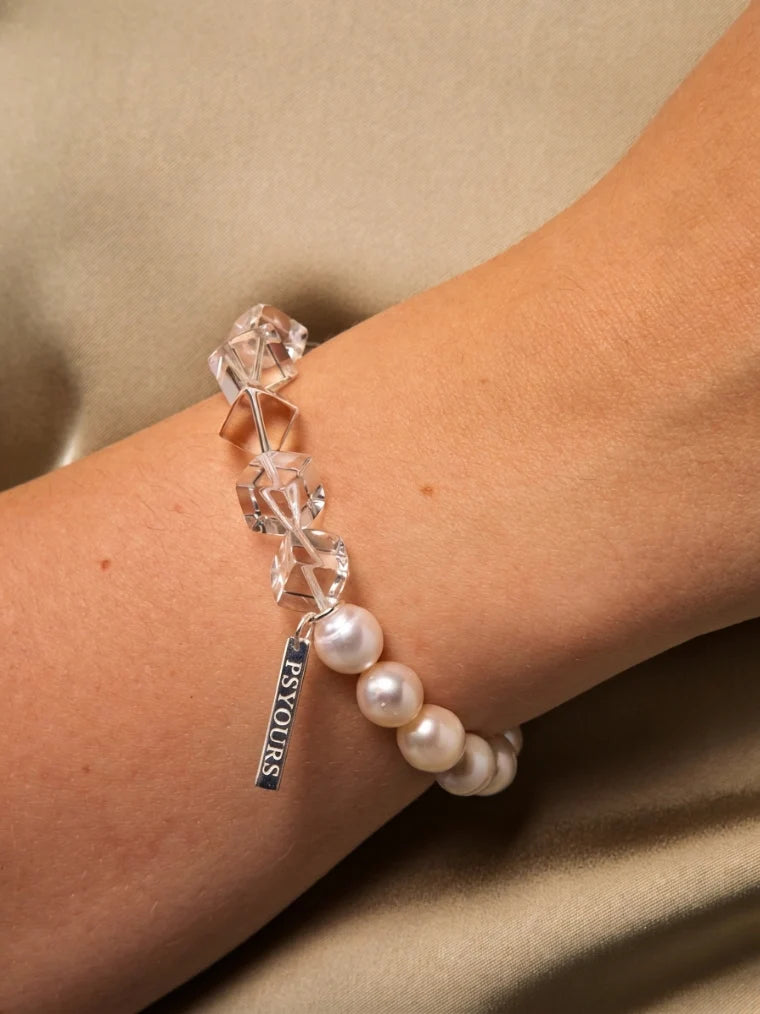 Close-up of the freshwater pearl and clear quartz bracelet worn on the wrist