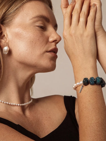 Model wearing a blue apatite and freshwater pearl beaded bracelet