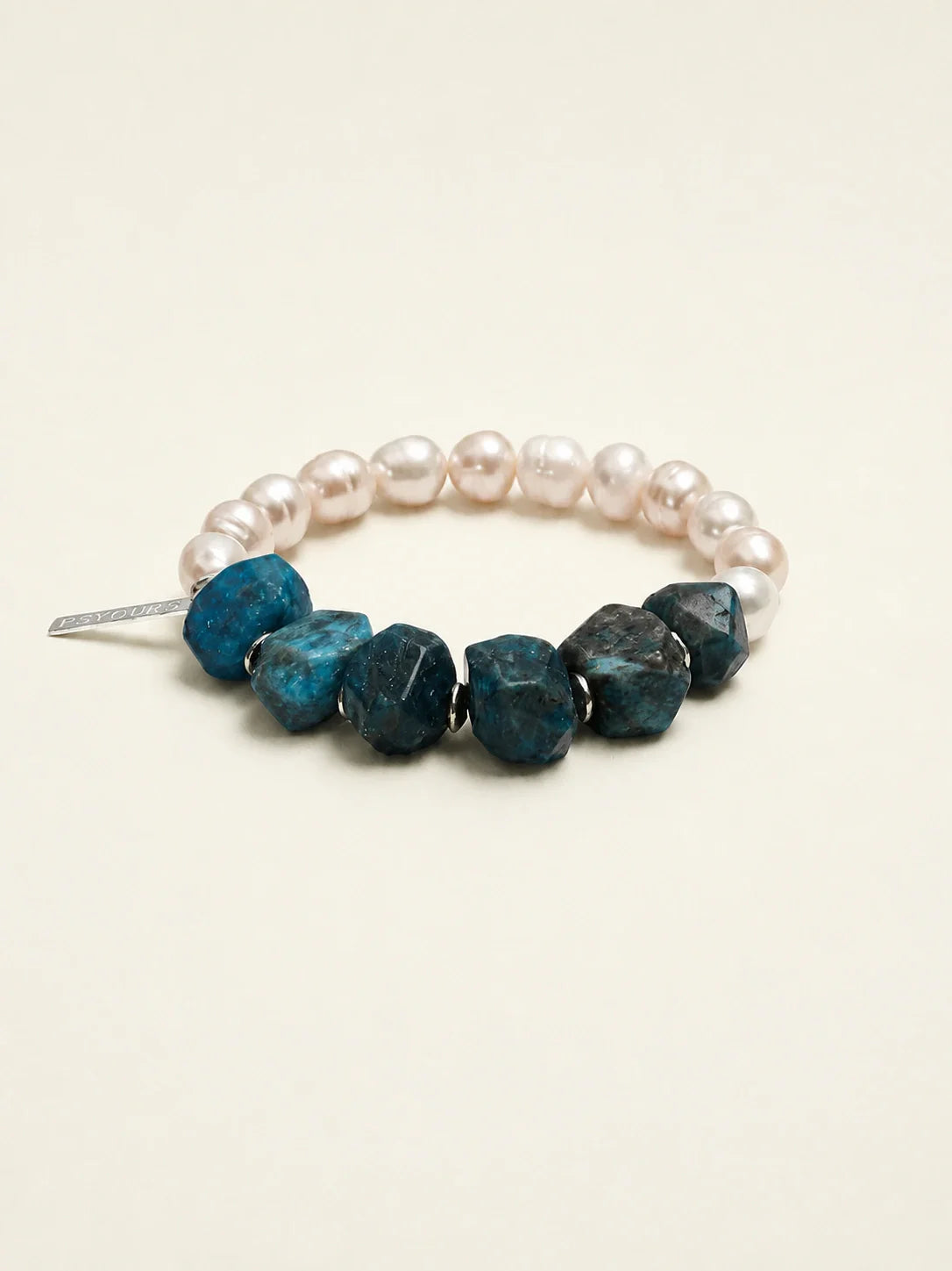 Freshwater pearl and blue apatite beaded bracelet on warm ivory background