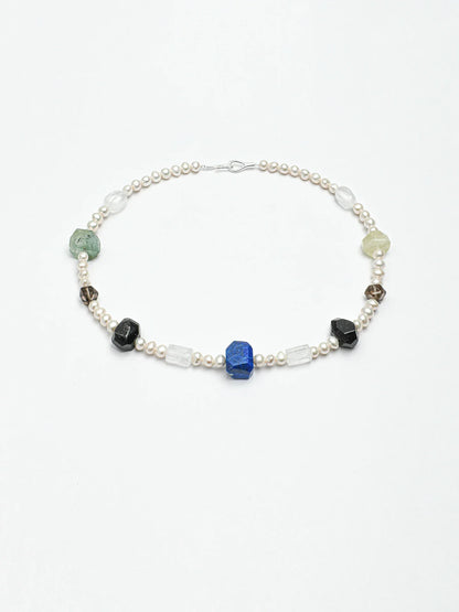 Model styling pearl earrings with a natural gemstone pearl necklace; earrings are not included