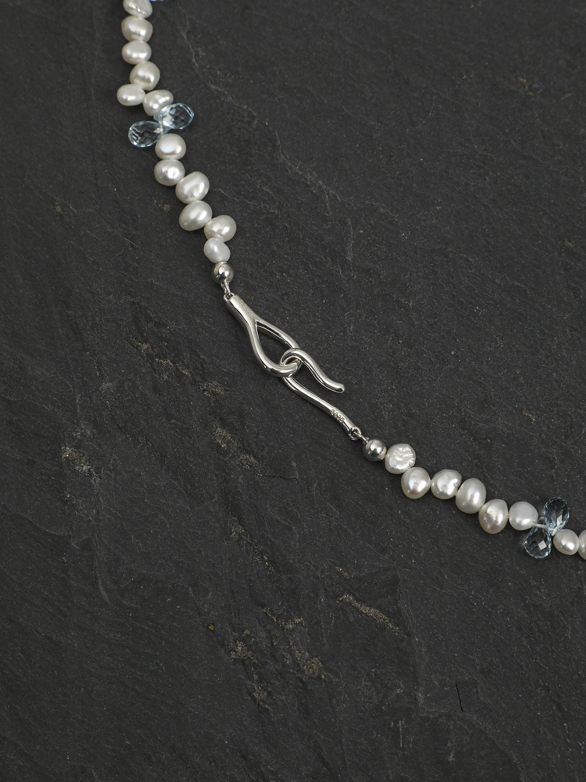 Close-up of the 925 silver question-mark hook clasp and pearl strand