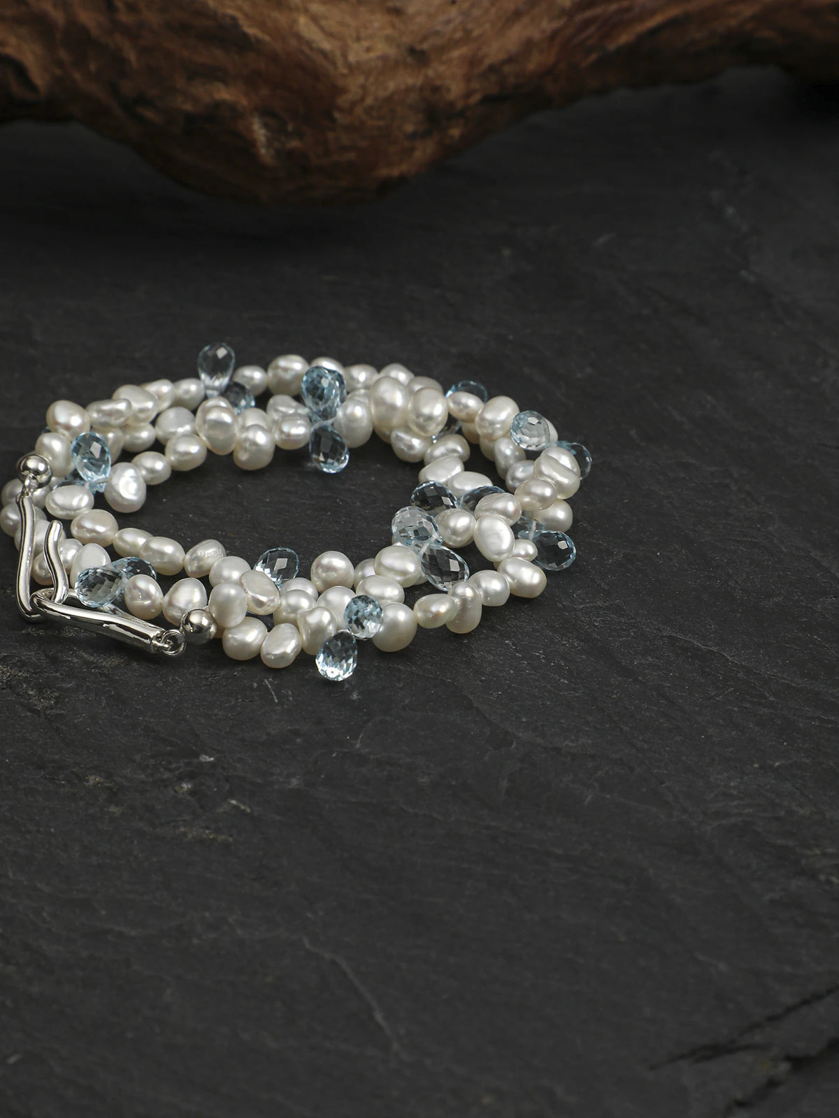 Coiled pearl and blue topaz necklace showing the silver clasp and bead details
