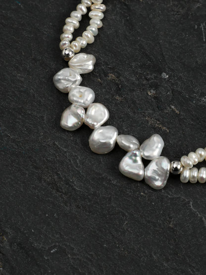 Close-up of the 925 silver spacer beads, clasp, and engravable round tag