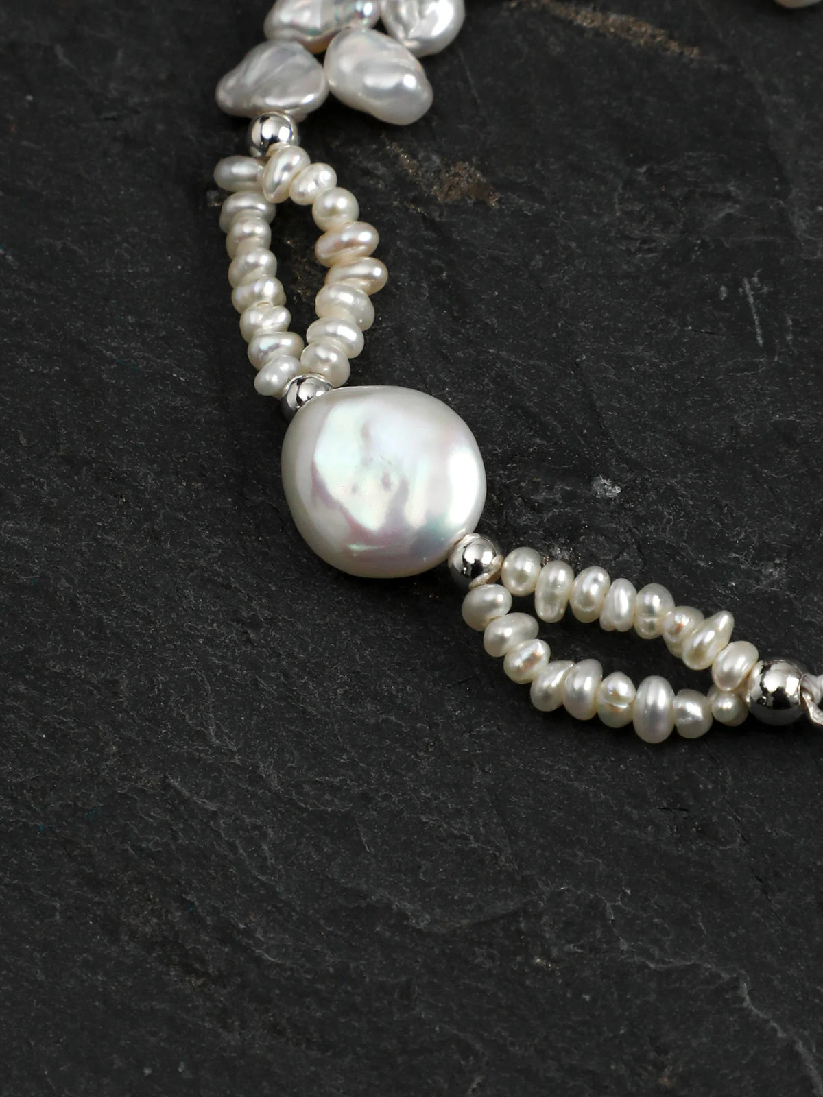 Close-up of the petal and drop baroque pearls with clear quartz columns