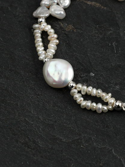 Close-up of the petal and drop baroque pearls with clear quartz columns