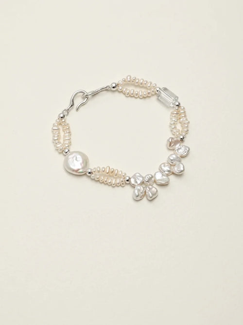Crashing Waves baroque pearl and clear quartz bracelet on a light background
