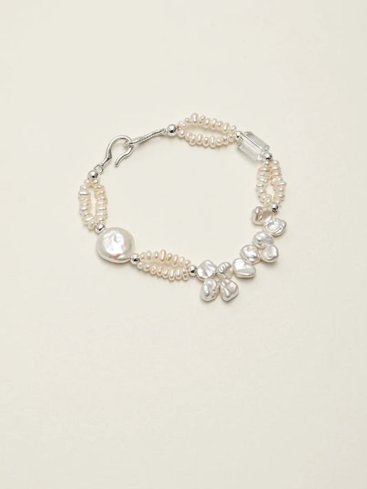 Crashing Waves baroque pearl and clear quartz bracelet on a light background