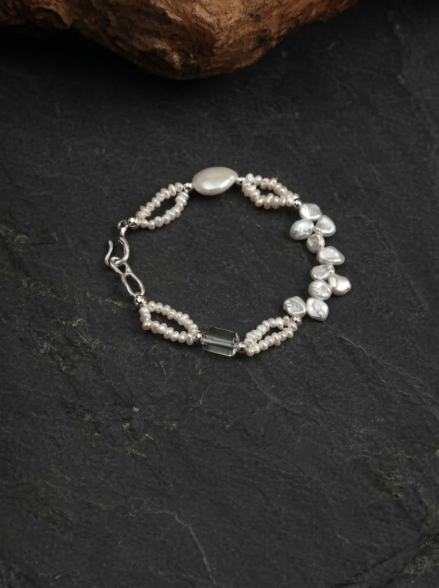 Crashing Waves bracelet showing layered baroque pearls and clear quartz columns