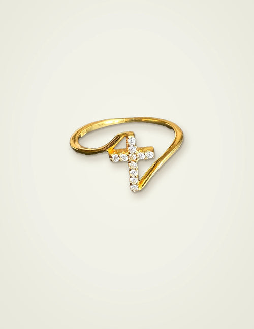 Dainty cross ring in 14K gold plated 925 sterling silver with CZ stones on a cream background