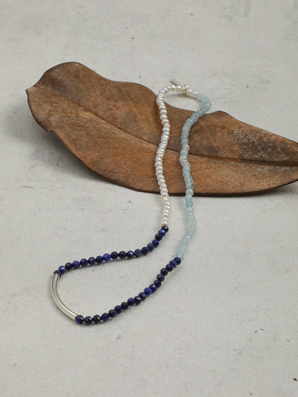 Full view of the layered bracelet set on a wrist