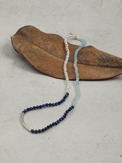 Full view of the layered bracelet set on a wrist