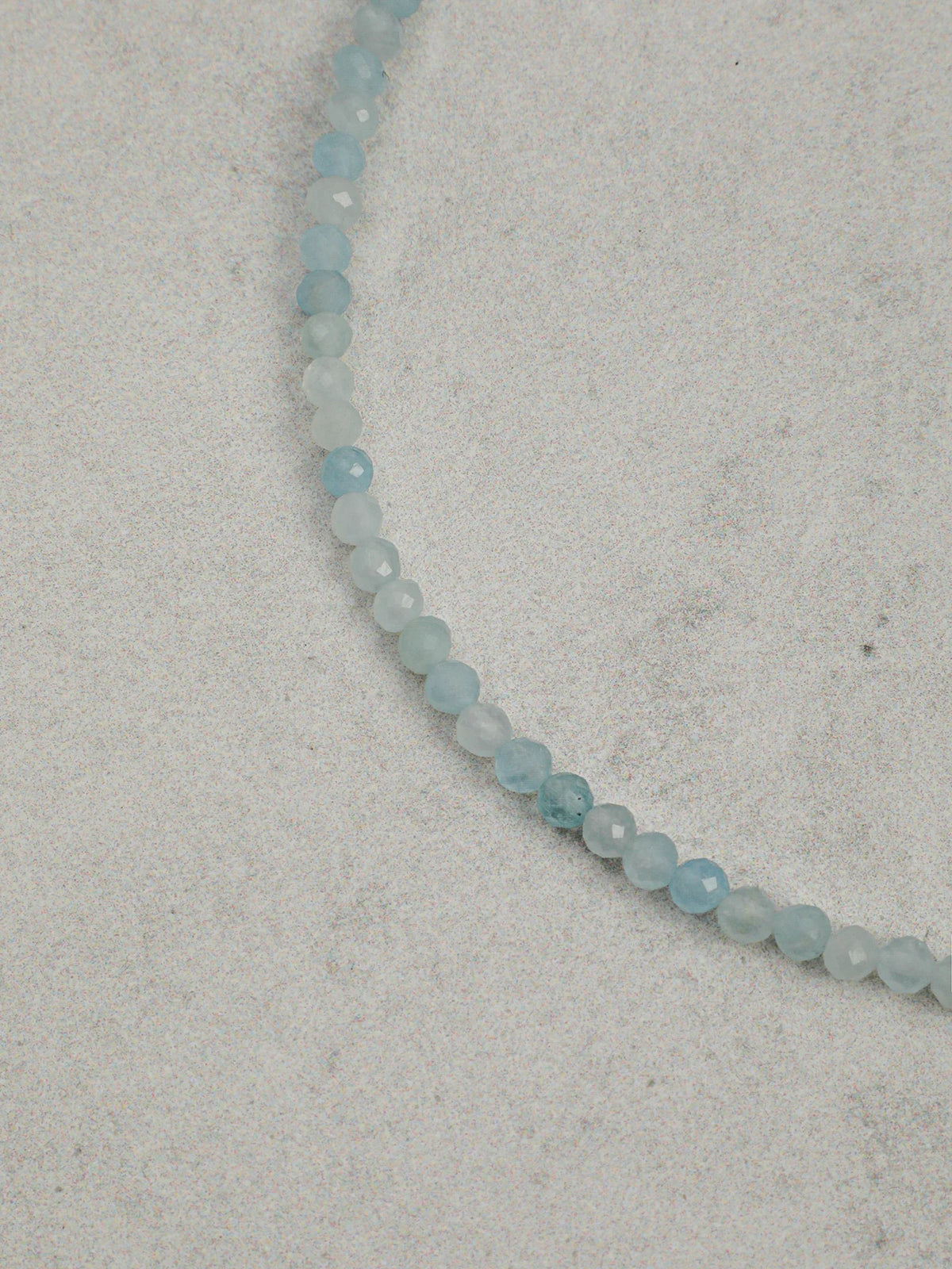 Close-up of the aquamarine, lapis lazuli, and freshwater seed pearls