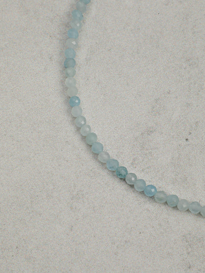 Close-up of the aquamarine, lapis lazuli, and freshwater seed pearls