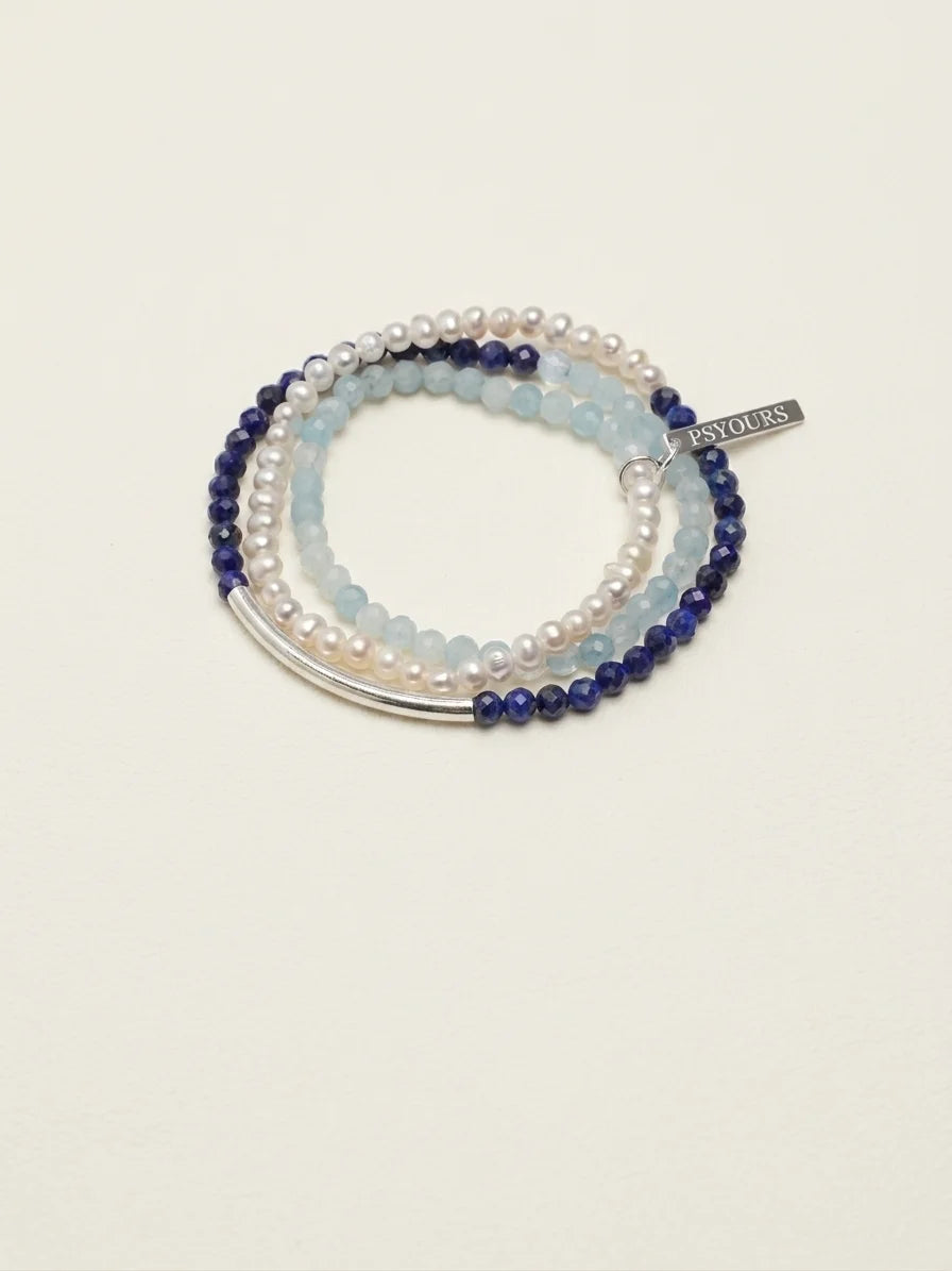 Deep Sea Tide aquamarine and lapis lazuli pearl bracelet set on a light background