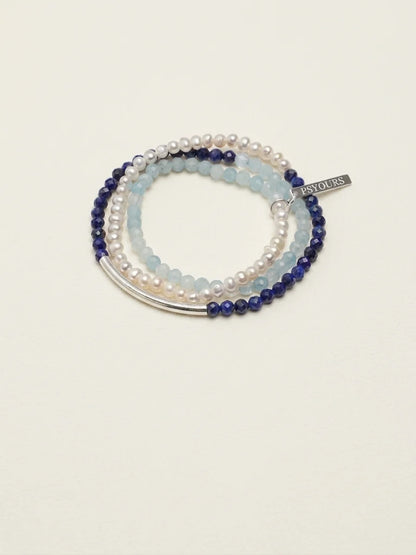 Deep Sea Tide aquamarine and lapis lazuli pearl bracelet set on a light background
