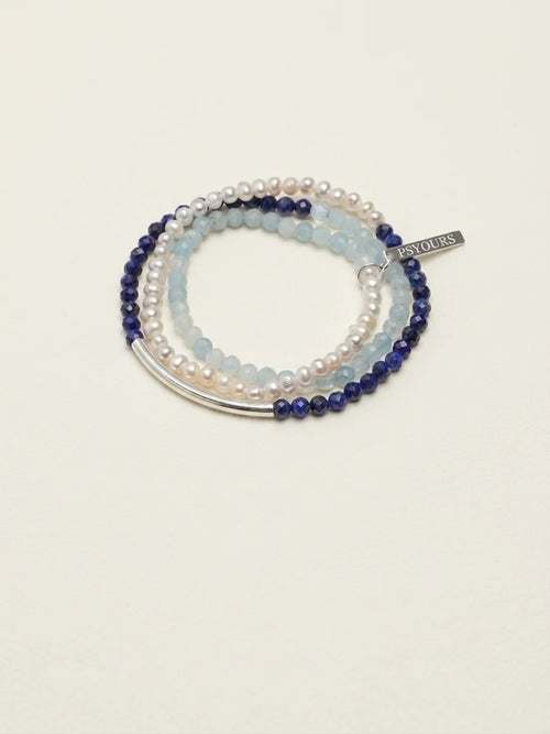 Deep Sea Tide aquamarine and lapis lazuli pearl bracelet set on a light background
