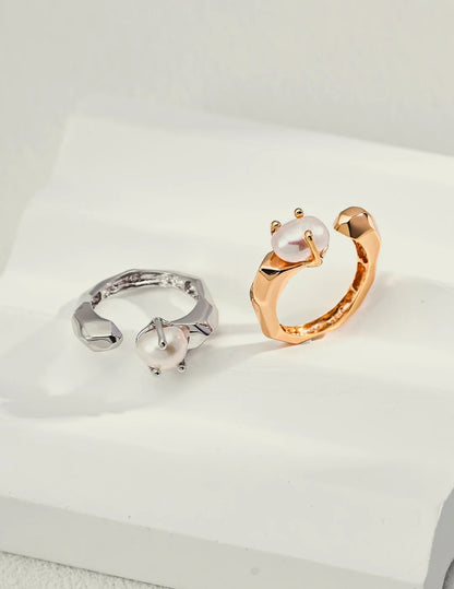 Faceted Pearl Claw Open Ring in gold and silver shown together