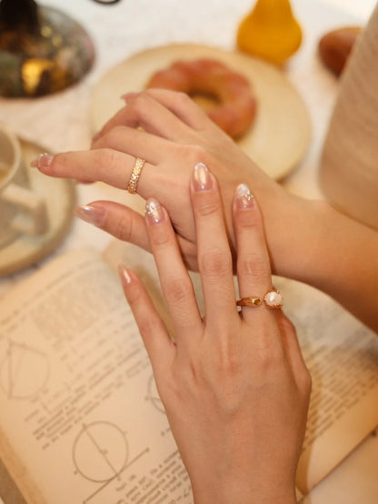 Faceted Pearl Claw Open Ring in gold styled with a stacking ring