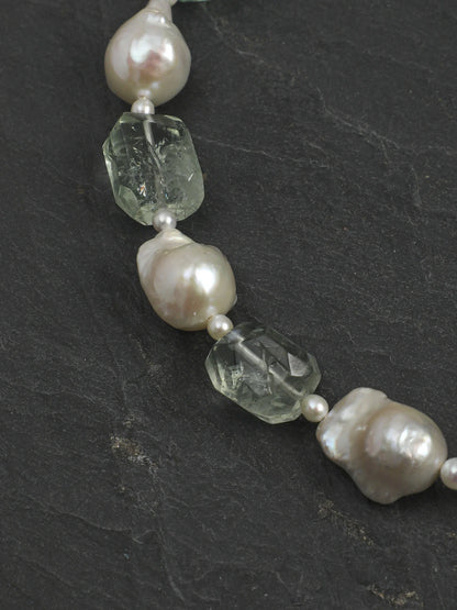 Close-up of freeform natural green quartz and large baroque pearls