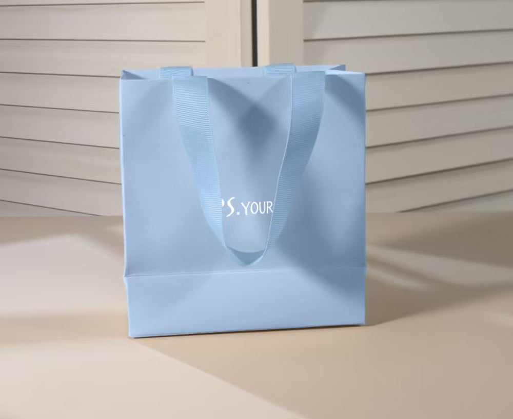 Psyours light blue branded gift bag, actual packaging photograph.
