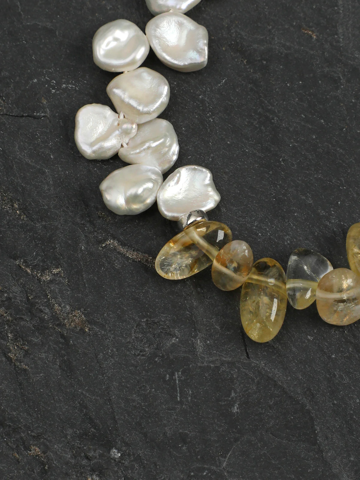 Close-up of the 925 silver spacer beads, bubble beads, and engravable round tag