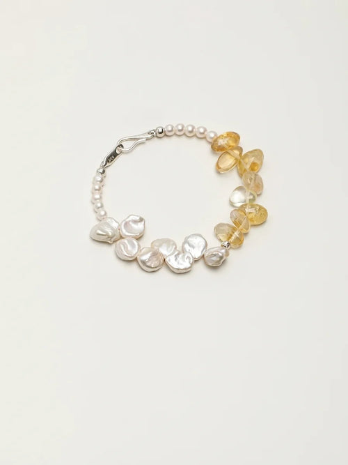 Golden Bloom petal pearl and citrine bracelet on a light background