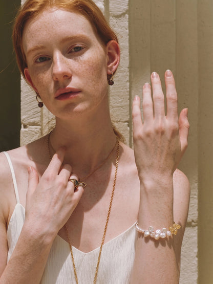 Illustrative styling image of the Golden Bloom bracelet worn on the wrist