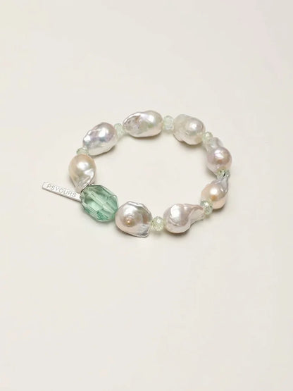 Psyours Misty Green baroque pearl and prehnite bracelet, flat lay on cream background