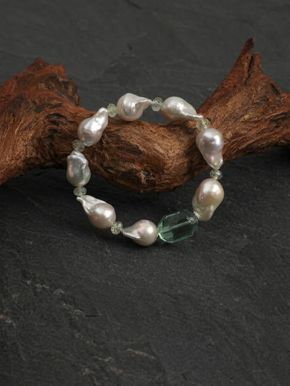 Close-up detail of baroque pearls and prehnite beads on the Psyours Misty Green bracelet