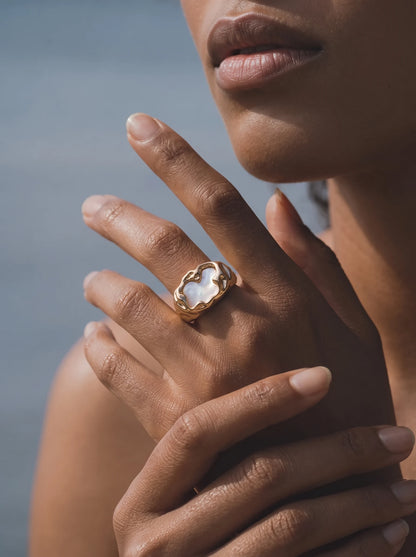 Model wearing the Molten Mother-of-Pearl Open Ring in warm sunlight
