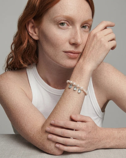 Model wearing the Ocean Tears pearl and blue topaz bracelet on her wrist