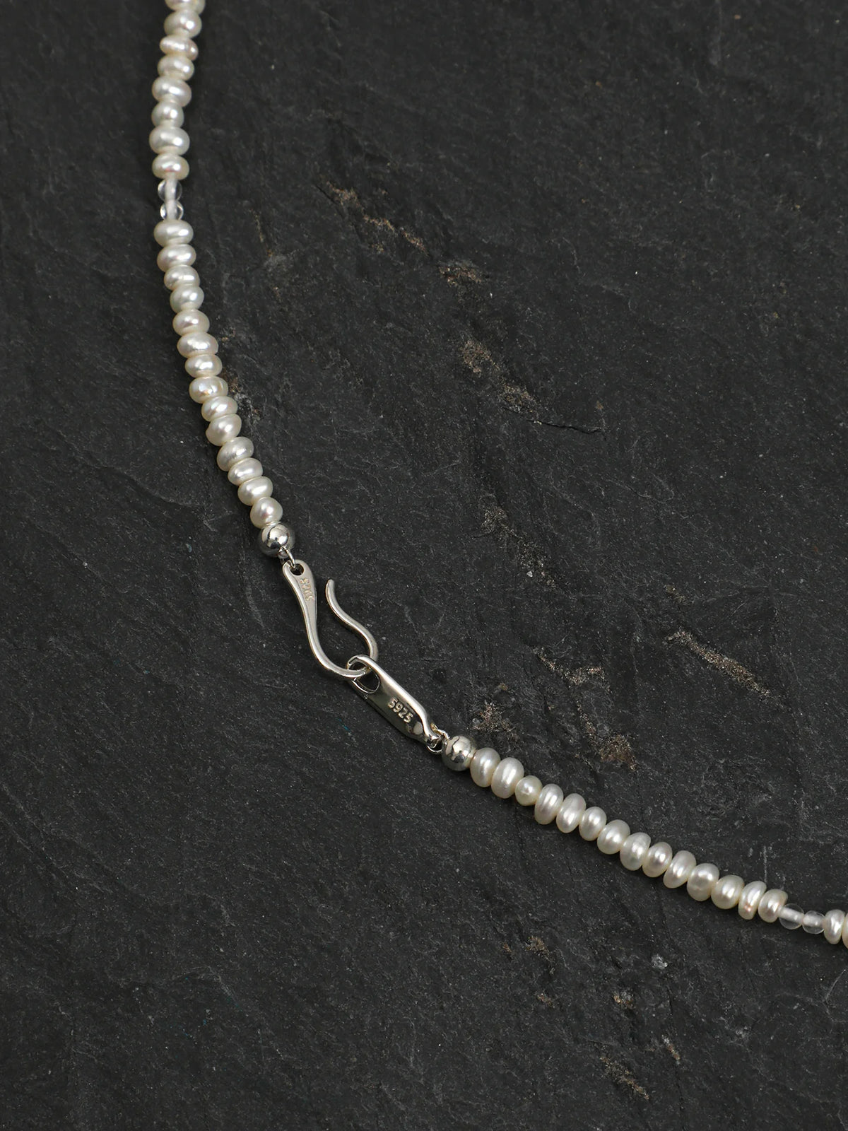 Close-up of the dangling blue topaz teardrops and clear quartz beads