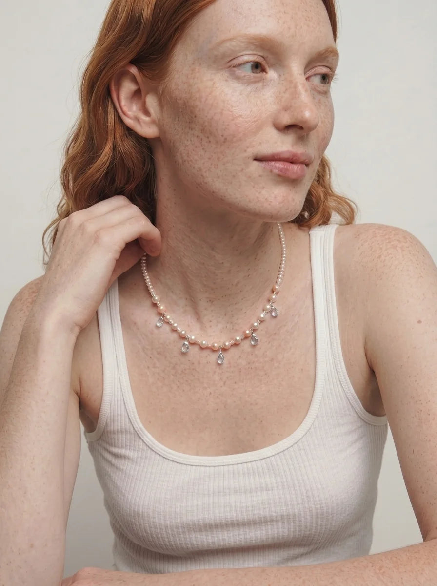 Illustrative styling image of the Ocean Tears necklace worn at the collarbone