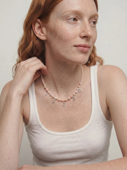 Illustrative styling image of the Ocean Tears necklace worn at the collarbone