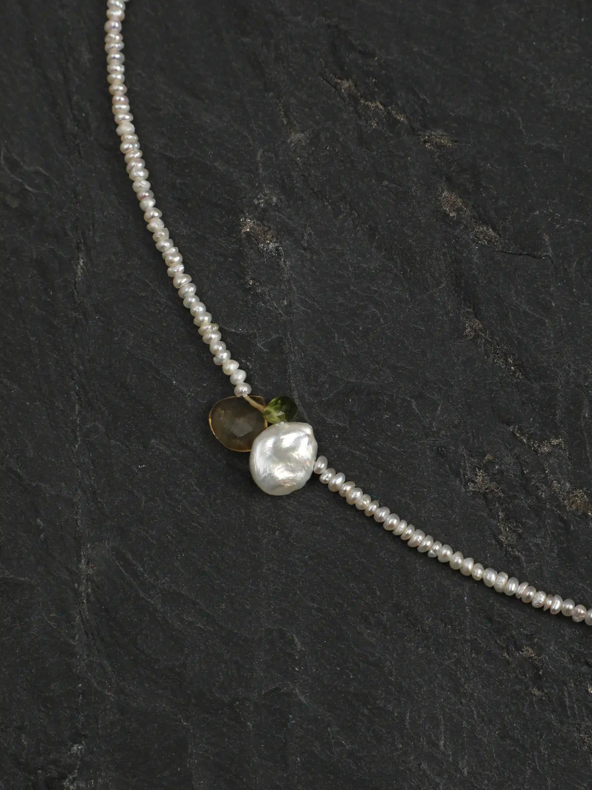 Close-up of the pearl and gemstone accents