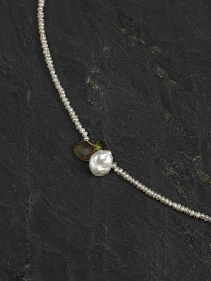Close-up of the pearl and gemstone accents