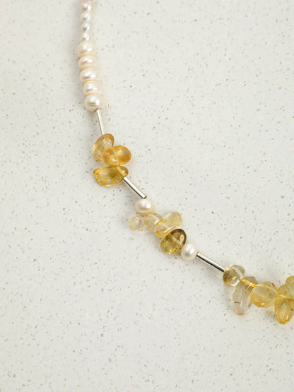 Close-up of citrine chips, pearls and silver tube spacers