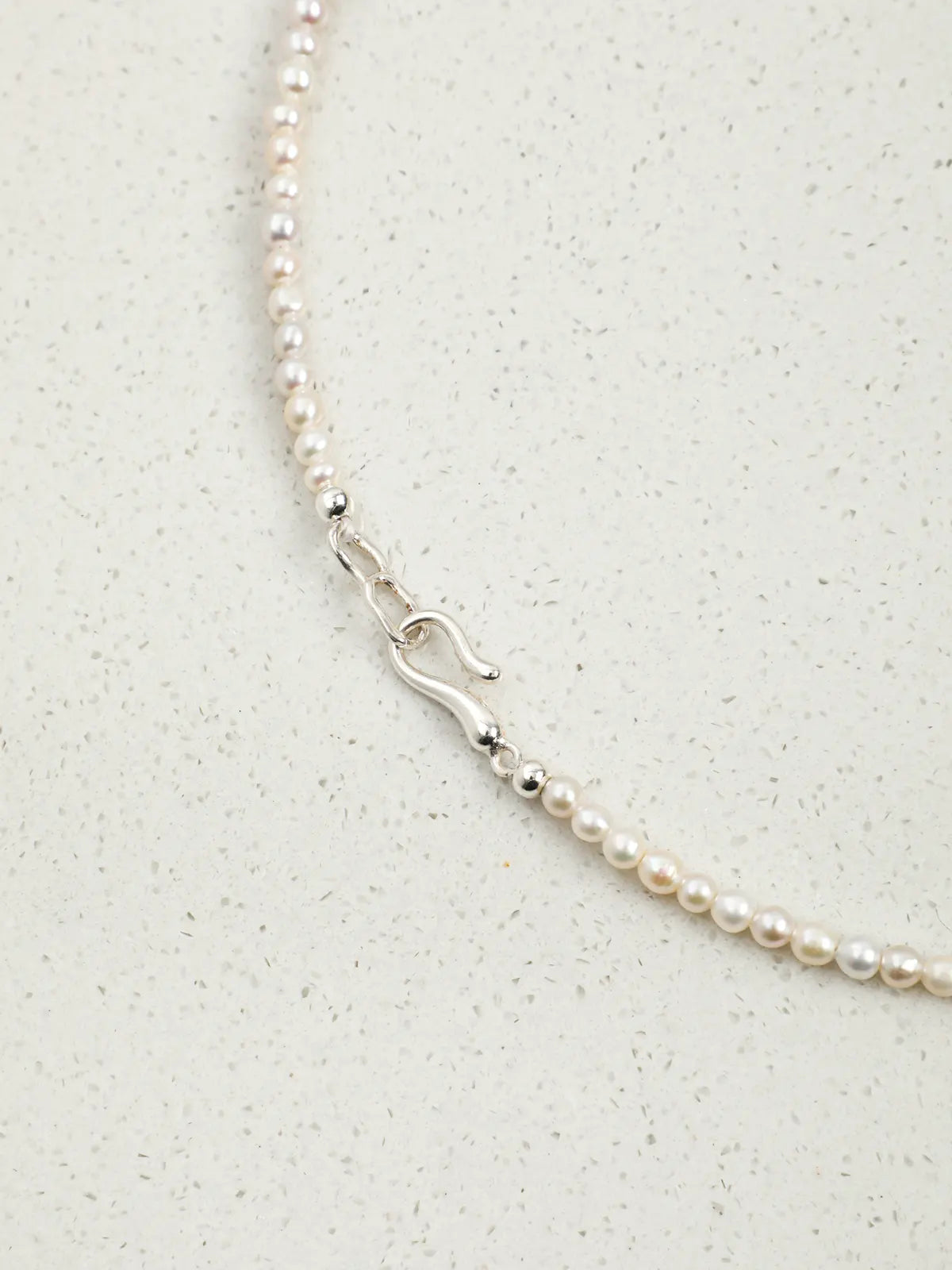Close-up of the S925 silver hook clasp and pearl strand