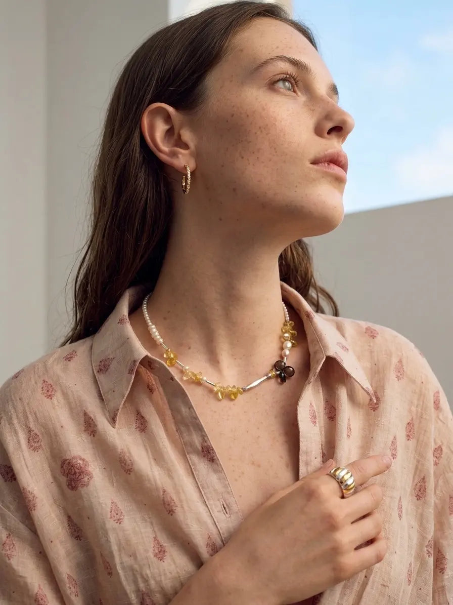 Side-view styling illustration of the Golden Sunlight necklace; other jewelry is not included