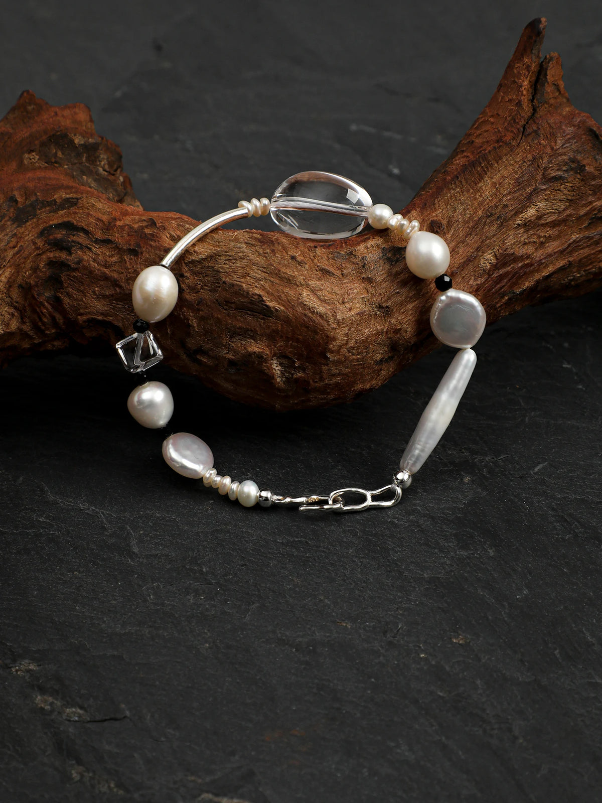 Psyours Pure Radiance bracelet styled on dark slate with driftwood