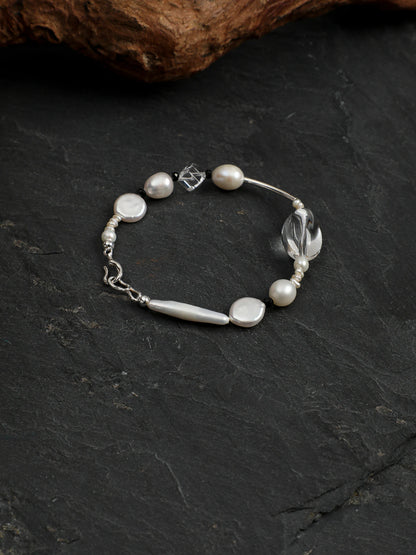 Psyours Pure Radiance bracelet on driftwood, showing sterling silver clasp detail